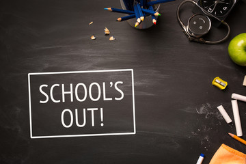 text school's out and school supplies on chalk Board top view