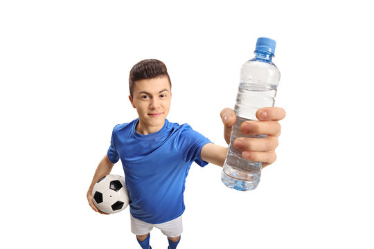 Teenage Soccer Player With A Football And A Bottle Of Water