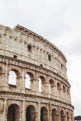 Fototapeta na wymiar famous Colosseum ruins on cloudy day, Rome, Italy