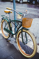 Fototapeta na wymiar vintage bicycle with basket parked on street of Rome, Italy