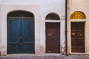 Obraz na płótnie Canvas three wooden doors in buildings in Rome, Italy