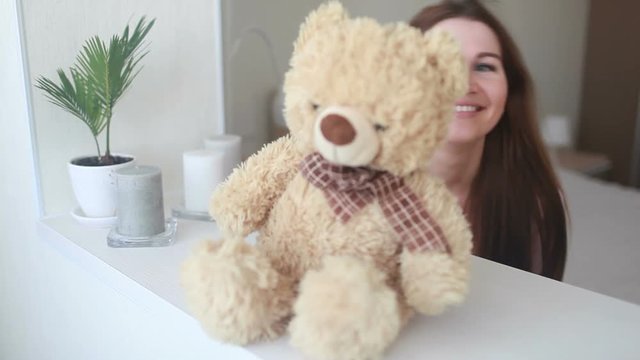 Beautiful girl playing with soft toy