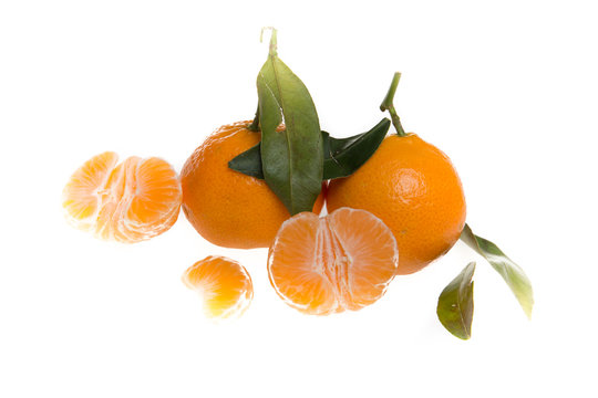 clementines or tangerines with the leaves just picked over white background