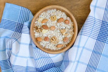 Bowl of muesli on wooden table.