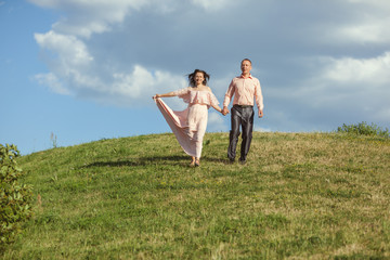 Man and woman running down the hill.