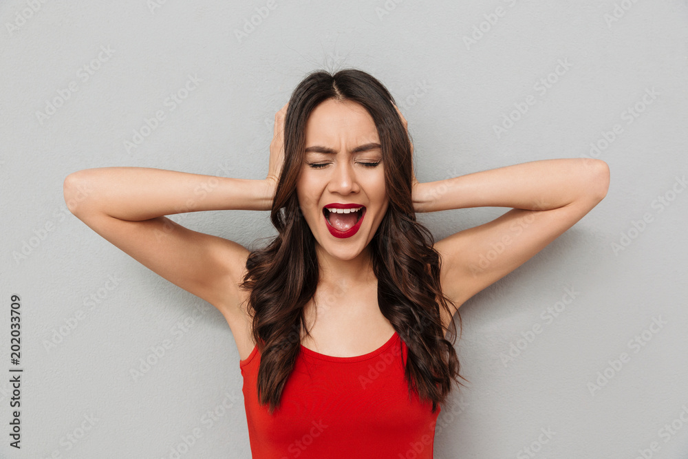 Poster Angry brunette woman in casual clothes covering her ears