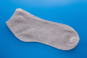 grey sock on blue background