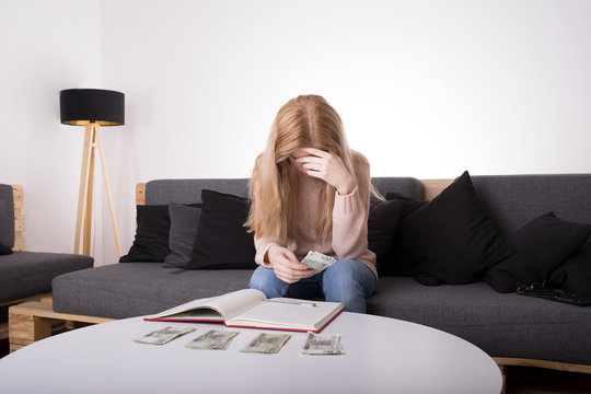 Sad young woman worrying about cash