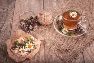 Cup of medicinal chamomile tea on a wooden