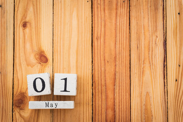 Wooden Block calendar for Labour Day, May 1 with blank space on wooden table background texture.