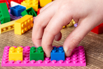 Child playing with toy bricks
