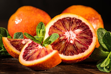 Whole and cut ripe juicy Sicilian Blood oranges