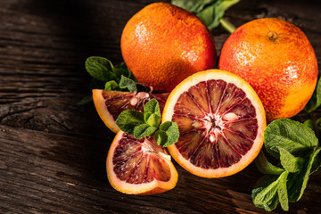 Whole and cut ripe juicy Sicilian Blood oranges