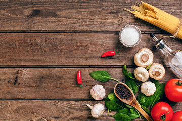 Italian food ingredients for the preparation pasta on wooden background