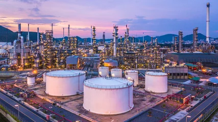 Fotobehang Aerial view oil and gas chemical tank with oil refinery plant background at twilight, business power and energy chemical barrel. © Kalyakan