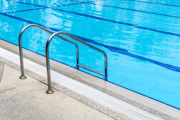 Swimming pool with stair at hotel close up.