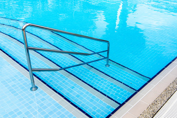 Swimming pool with stair at hotel close up.