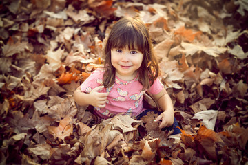 Little girl in autumn park