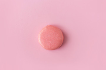 Colored macaron in a pink background , colorful almond cookie, pastel color, vintage card, top view