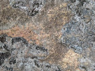 Old stone texture background. Beautiful rock surface covered with lichen