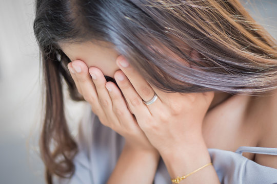 crying girl doing face palm; unhappy sad woman crying; portrait of frustrated, sad, failed asian woman cries and doing face-palm with failure, frustration, bad news; asian woman young adult model