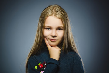 Closeup Thoughtful girl with Hand at head isolated on Gray