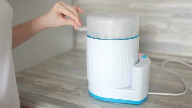 Baby bottle steamer machine for bottle cleaning.