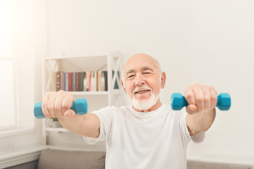 Senior man making exercise with dumbbells