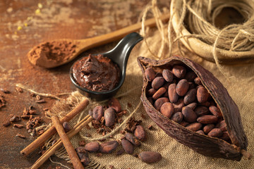 Cocoa pod ,beans and cocoa nibs setup on rustic wooden background