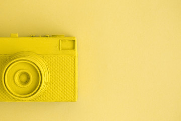 Flat lay of yellow colored retro camera surrealism abstract concept