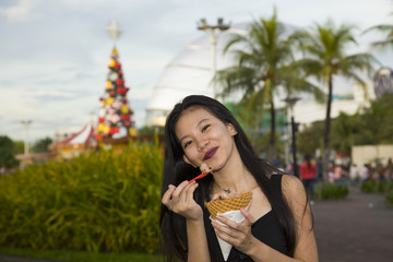 Fototapeta premium Filipina Enjoying Ice Creat at the Amusement Park
