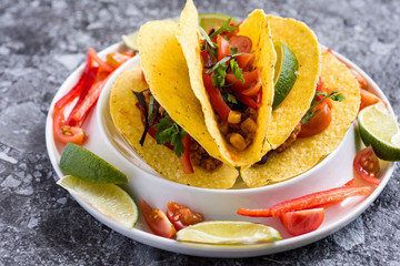 Tacos in Shells with Vegetables on Stone Background