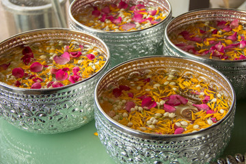 Thai traditional jasmine garland and Rose petals flower on the water