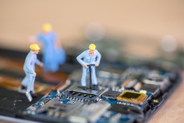Miniature worker, technician repairing Mobile Repairer
