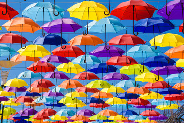 Fototapeta na wymiar Multicolored umbrellas on the street