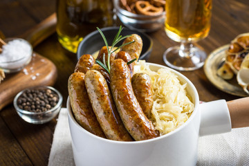 Traditional German Sausages with Cabbage Salad, Mustard and Beer. Bratwurst and Sauerkraut.