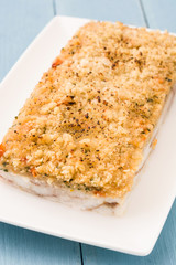 White fish casserole with cheese on blue wooden background. 