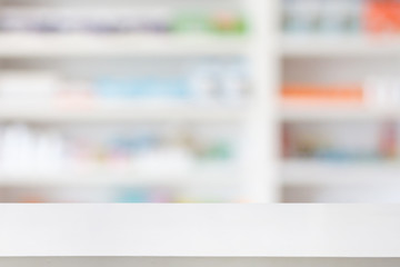 Pharmacy drugstore counter table with blur abstract backbround with medicine and healthcare product on shelves