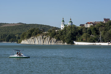 Fototapeta na wymiar lake with a catamaran and mountains in the background