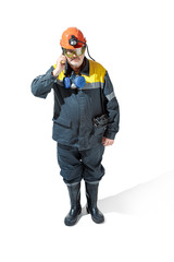 The studio shot of senior bearded male miner standing at the camera on a white background.