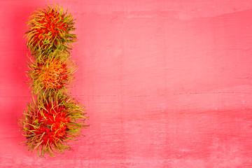 rambutan fruit on wood color pink