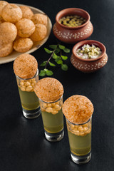 Pani Puri, a north Indian street snack made of fried puries and mint water which is all time favourite. © sudhas