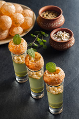 Pani Puri, a north Indian street snack made of fried puries and mint water which is all time...
