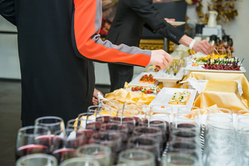 Catering buffet table with food and snacks for guests of the event. Group of people in all you can eat. Dining Food Celebration Party Concept. Service at business meeting, weddings. Selective focus.