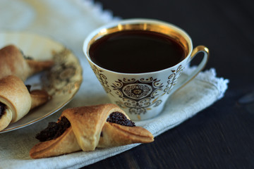 Coffee and cake on a dark background. French breakfast. Top view. Copy space.
