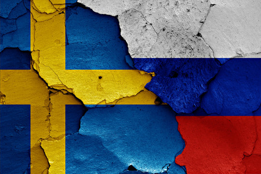 flags of Sweden and Russia painted on cracked wall