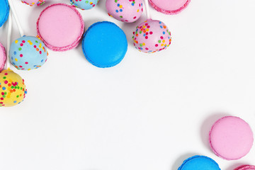 Set of bright colorful cakes on a white background with copy space. Assorted cookies. Festive dessert. Top view.