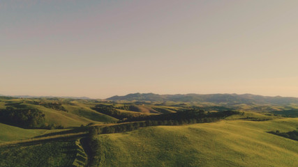 Tuscany hills landscape at sunset aerial view