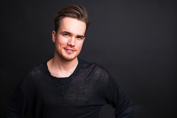 Studio portrait of young man on a dark background