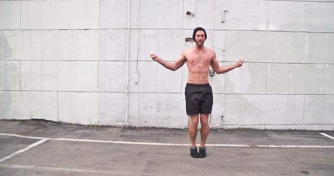 Athletic male working out in an empty parking lot. Crossfit. Slow Motion.